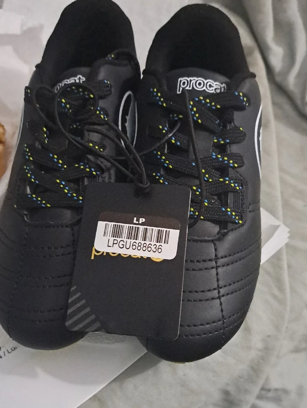 Puma Kids Black Soccer Cleats with Yellow Sole and Blue Studs